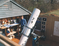 The author fights dew in his observatory in two ways: his 12½-inch reflector has an extra-long tube, and his roll-off roof hangs partway over his worktable, protecting charts and accessories from radiational cooling.