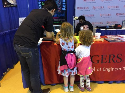 Two children inspect the Rutgers Engineering booth
