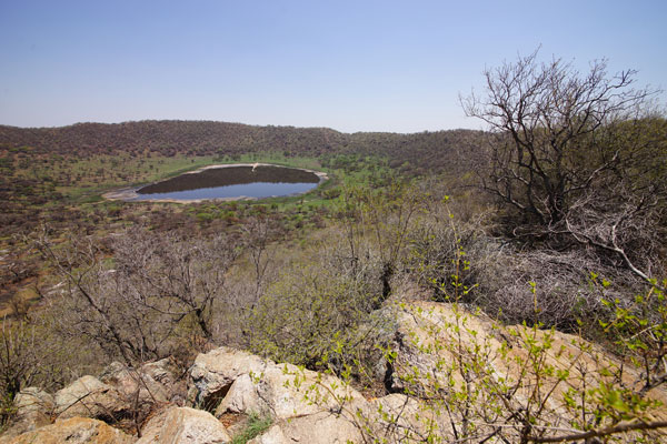 Standing on the rim of the 1.1-kilometer Tswaing crater, just north of Pretoria, provides a good view of the lake at the crater floor.
