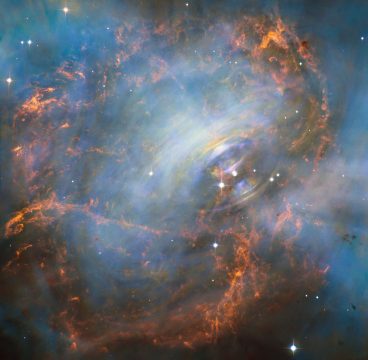 This image shows the very heart of the Crab Nebula including the central neutron star — it is the rightmost of the two bright stars near the center-right of this image. The rapid motion of the material nearest to the central star is revealed by the subtle rainbow of colors in this time-lapse image, the rainbow effect being due to the movement of material over the time between one image and another. NASA, ESA