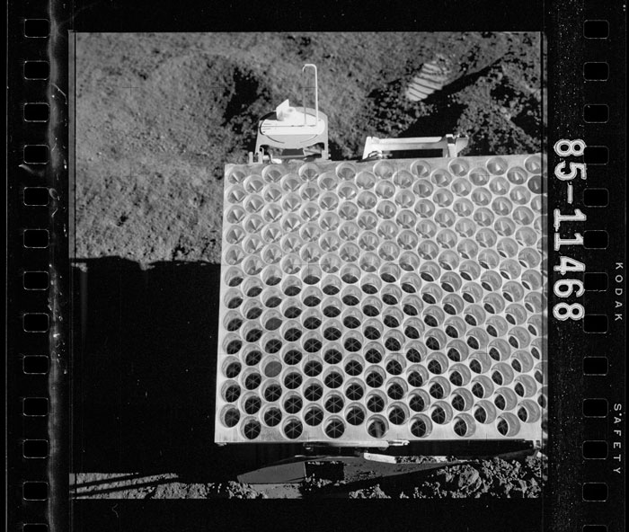 an image of a device resting on the lunar surface, that appears as a white square gridded with circles.