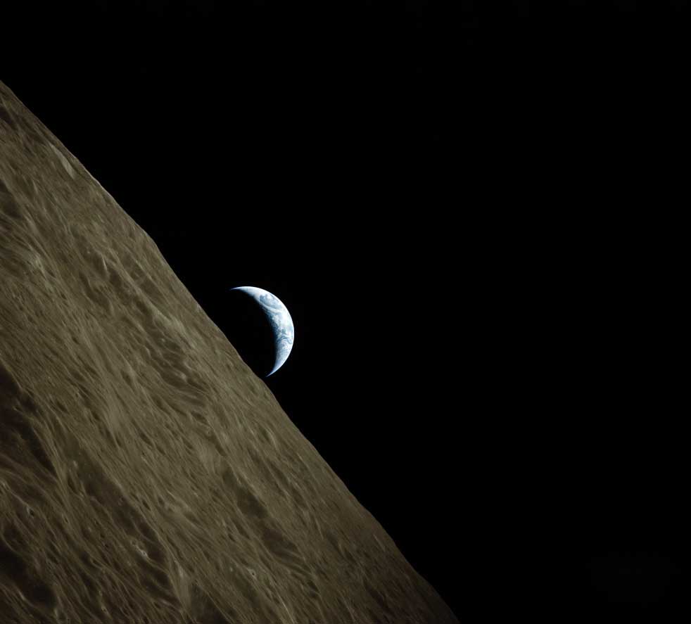 the earth in partial shadow with the moon in the foreground