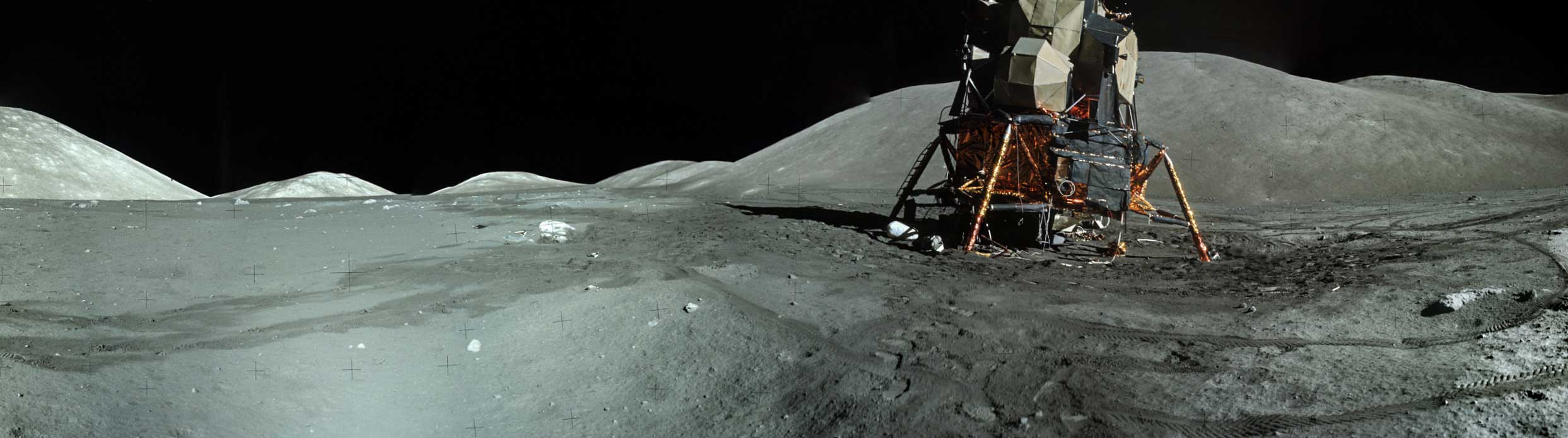 a wide shot of the moon landscape with a module on it