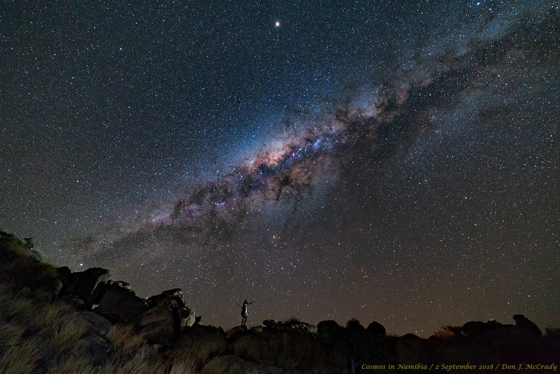 Stargazer standing beneath the Milky Way