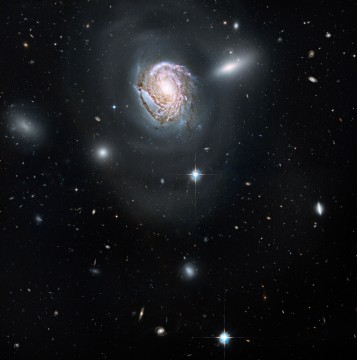 Spiral galaxy NGC 4911 against star field