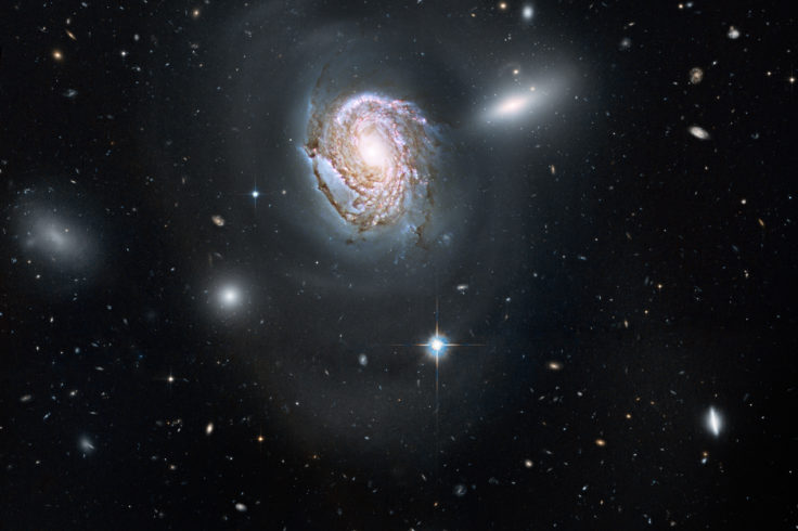 Spiral galaxy NGC 4911 against star field