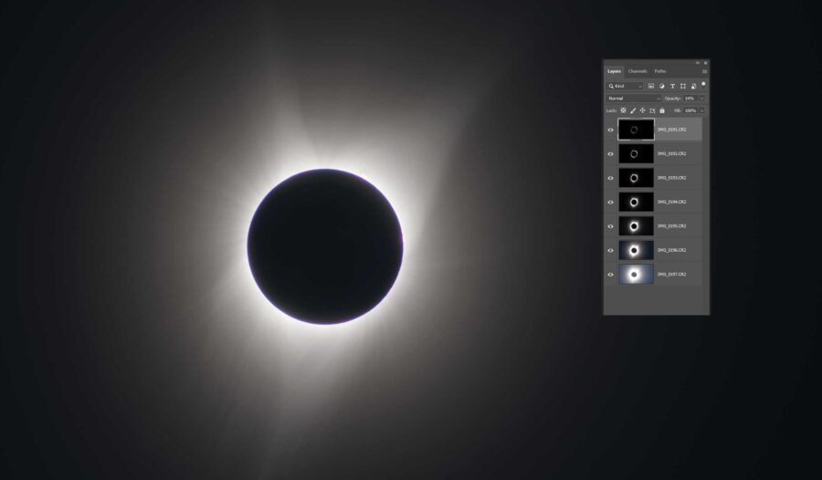 a black circle in the middle is surrounded by a ring of light against a dark background with a side panel showing layers in photoshop