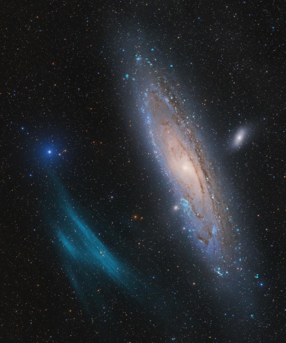 Photo of Andromeda Galaxy with a couple green glowing stripes at lower left