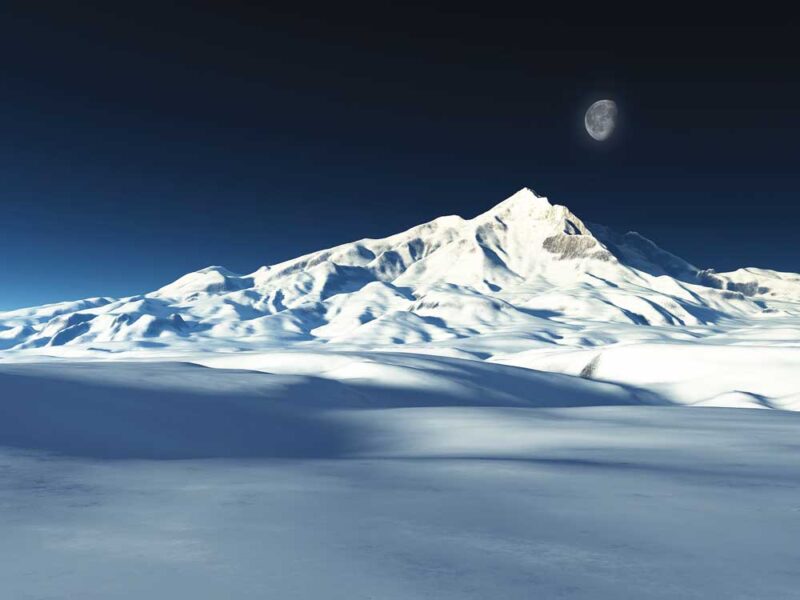 a snow covered mountain with a moon above it and snow in the foreground