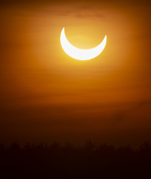 Partial solar eclipse above Auburn, New Hampshire