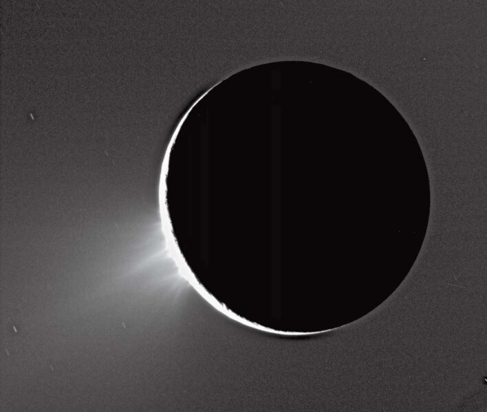 a sliver of white on the edge of a black cirlce on a grey background