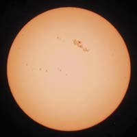 Sun with naked-eye sunspots captured with a digital camera for astrophotography.