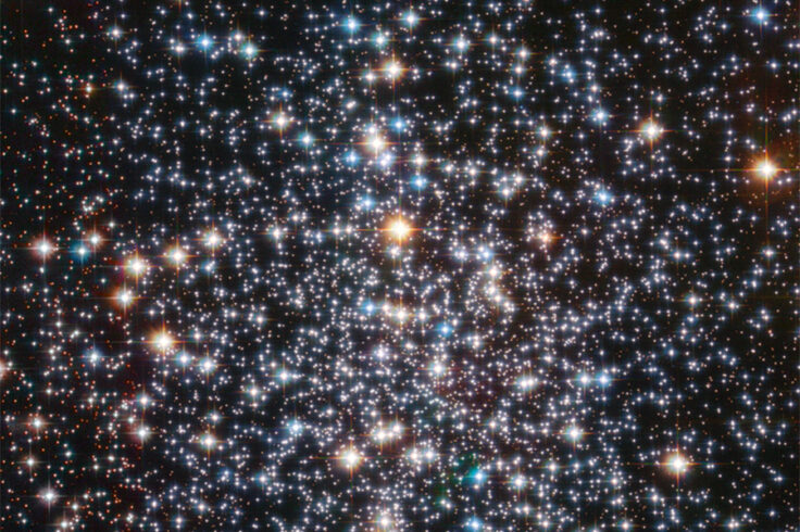 The center of a globular cluster with hundreds of thousands of stars colored red white and blue