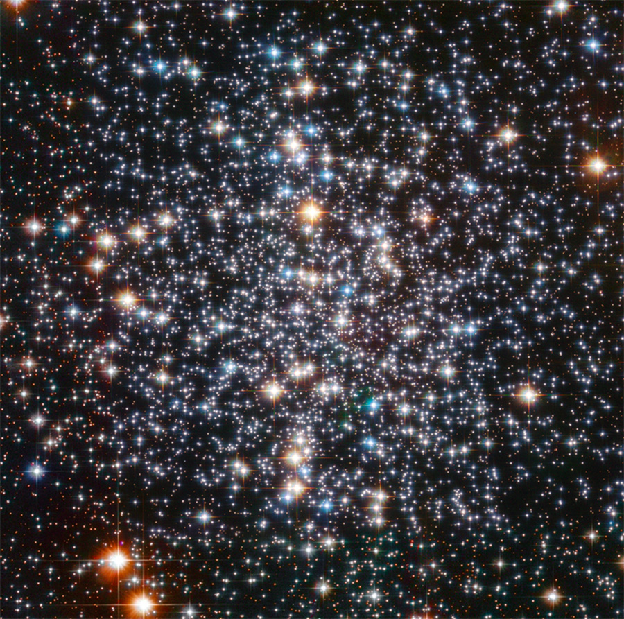 The center of a globular cluster with hundreds of thousands of stars colored red white and blue