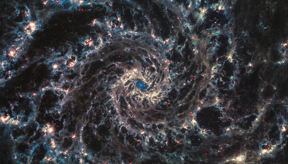NGC 628 looks like a giant blue-gold maelstrom with a blue middle