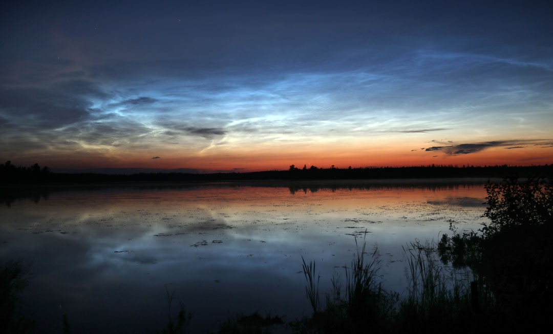Noctilucent clouds reflected in lake