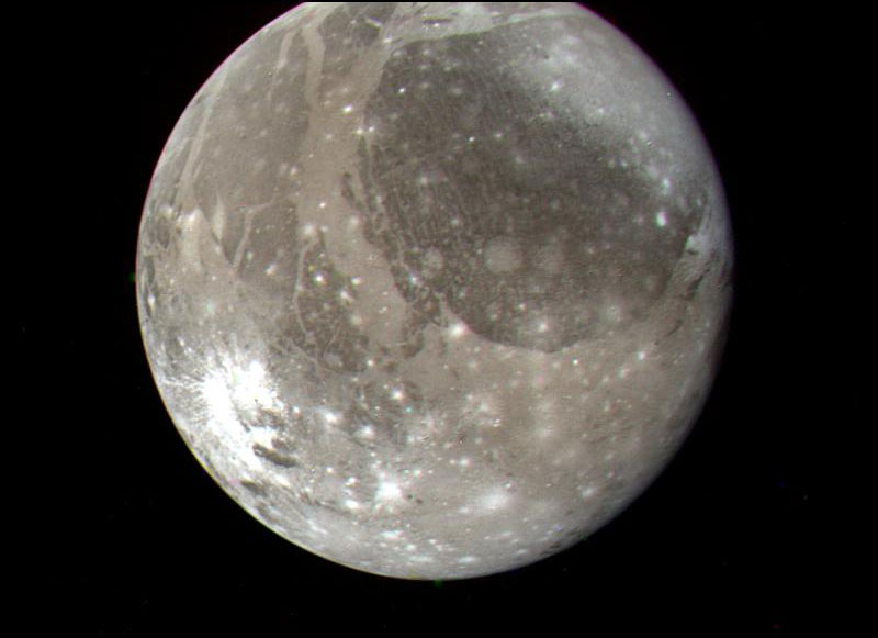 jupiter's moon ganymede shown in grey and white, against a black background
