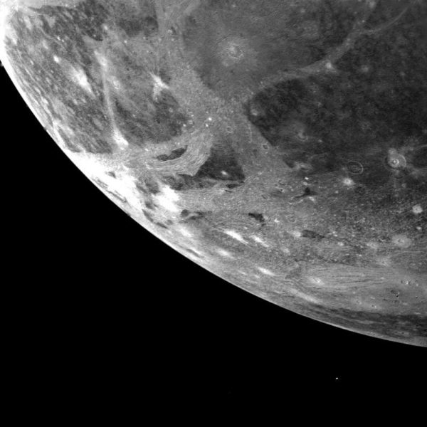 a closeup of the corner of Ganymede shown against a black background.
