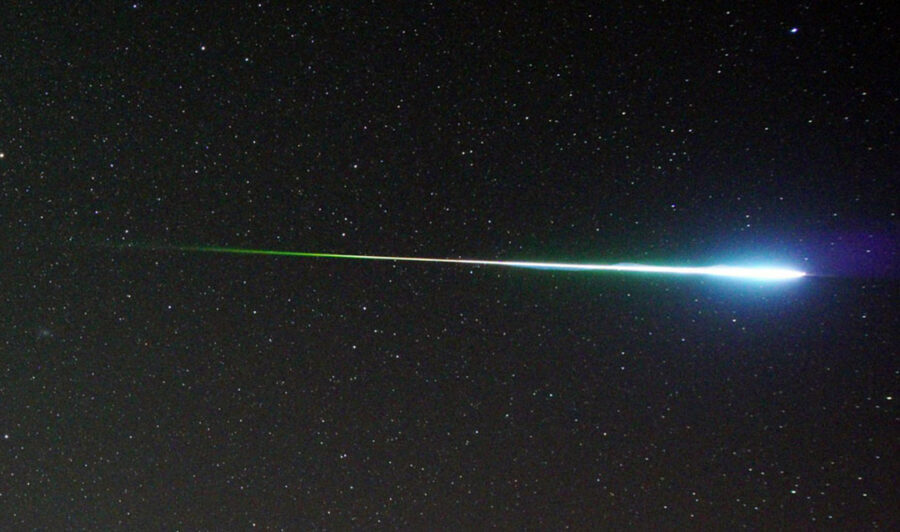 Colorful Perseid fireball shown in purple, blue, and green