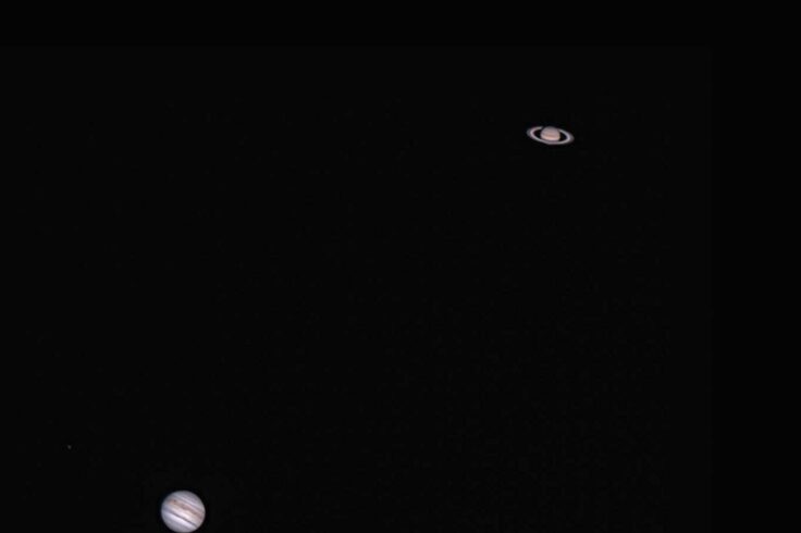 two planets on opposite corners on a black background