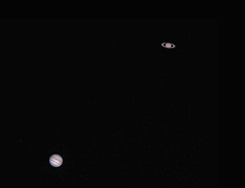 two planets on opposite corners on a black background