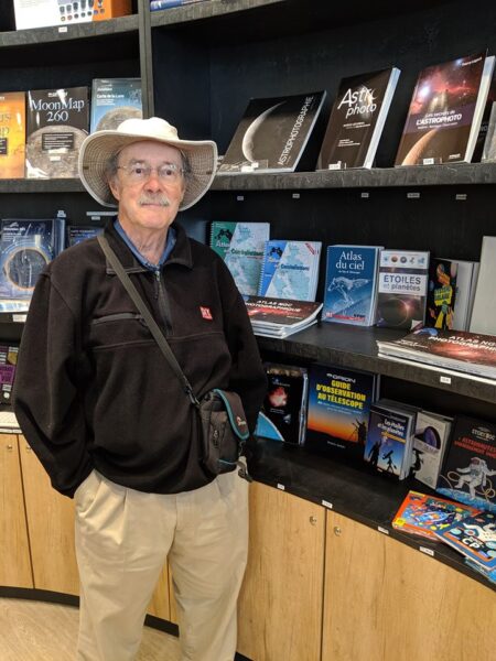 Roger Sinnott in front of the French version of the Pocket Sky Atlas. 