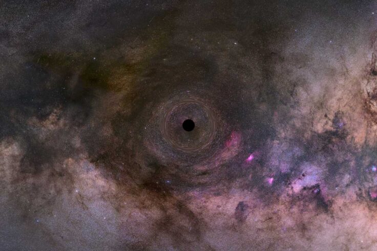 a black dot at the center of a swirl of pink, purple, orange, grey, and other colors