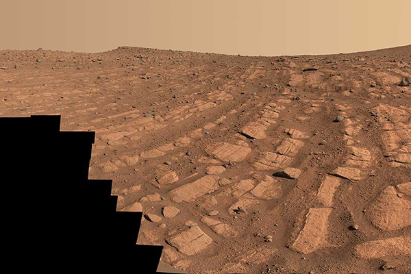 bands of red rocks on a red planet