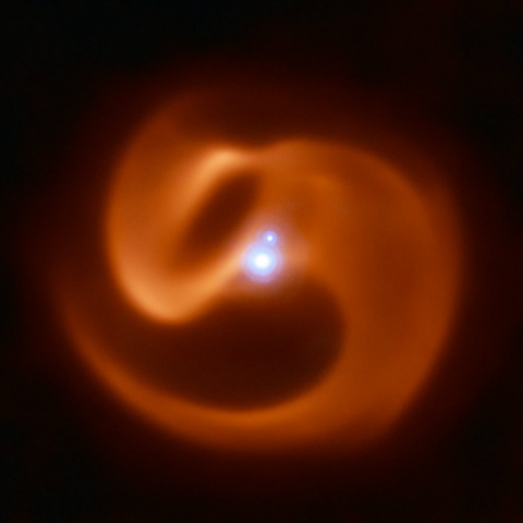 Image of a pinwheel of dust around a massive star