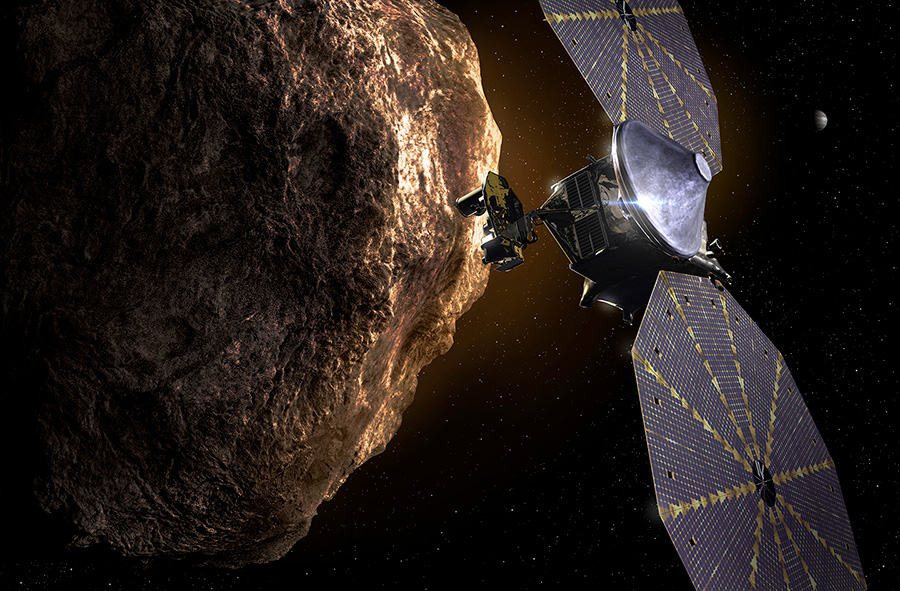 Lucy spacecraft next to shiny rock on black field