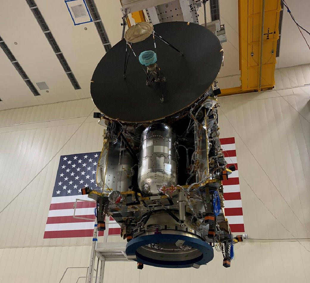 Lucy spacecraft in cleanroom with American flag on the back wall