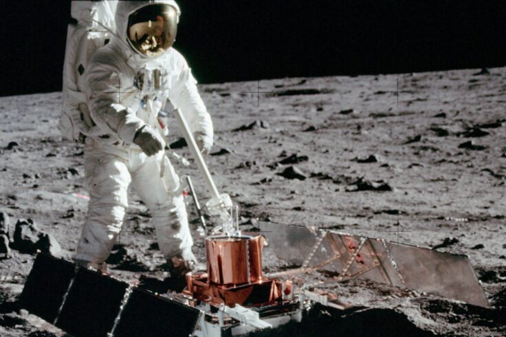 An astronaut from the Apollo 11 mission deploys a seismometer on the Moon.