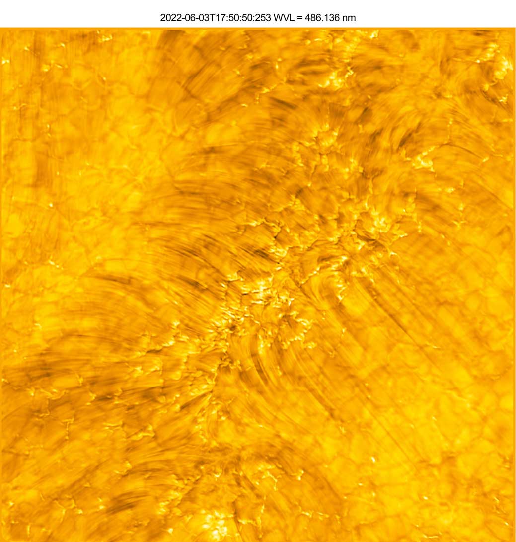 yellow image with darker spots leading down in line formations