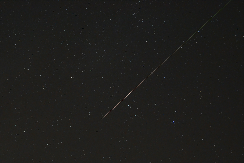 Meteor streak against star field