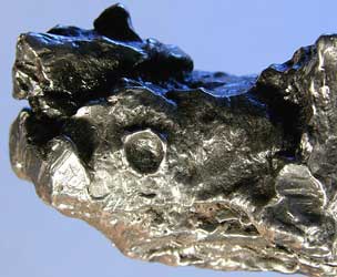 Meteorite with impact pit